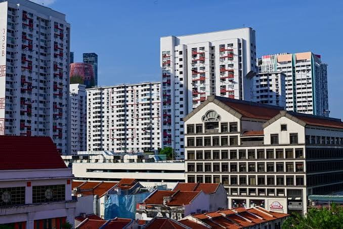 HDB flats, private apartments, and heritage buildings representing types of housing in Singapore