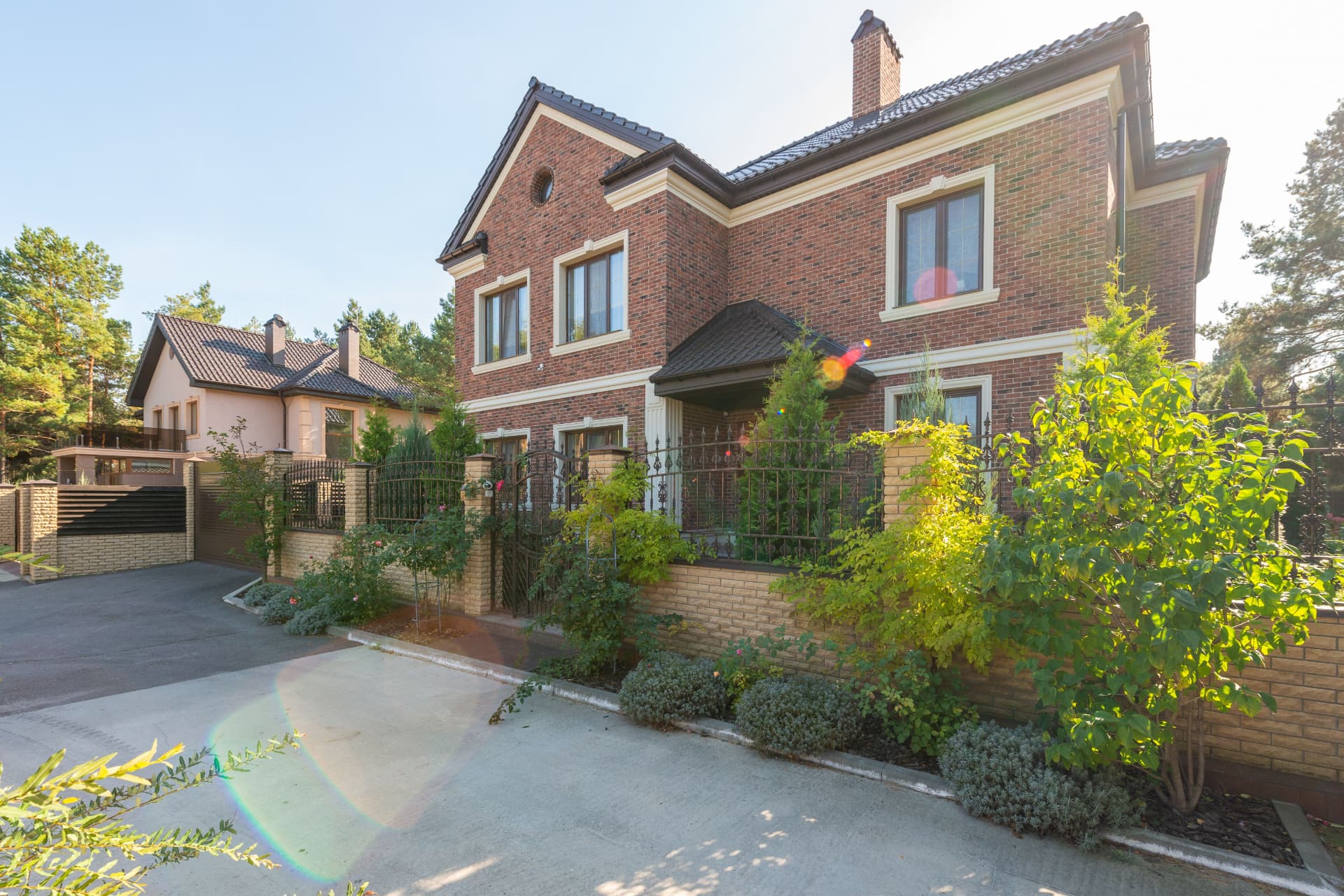 Semi-detached brick house with private driveway and greenery