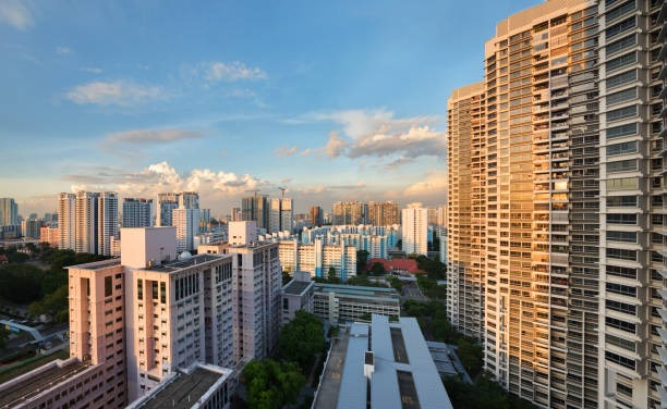 Singapore HDB blocks and private condominium towers at sunset, representing the 2026 decision to sell your HDB or condo