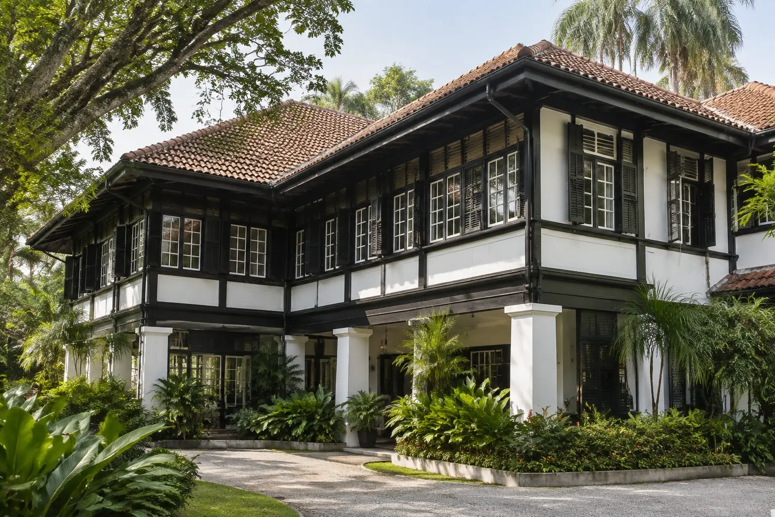 Black-and-white colonial bungalow exterior in Singapore surrounded by tropical greenery